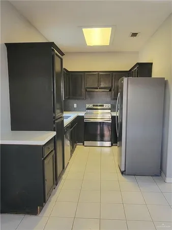 a kitchen with stainless steel appliances a refrigerator and a stove