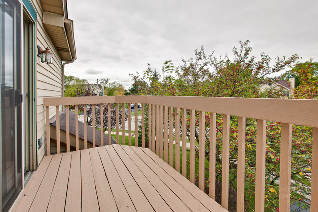 931 Ridgefield Lane Wheeling, IL 60090 - Photo 17 of 20 a balcony with wooden floor and fence