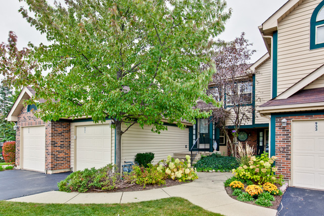 931 Ridgefield Lane Wheeling, IL 60090 - Photo 20 of 20 a front view of a house with a yard
