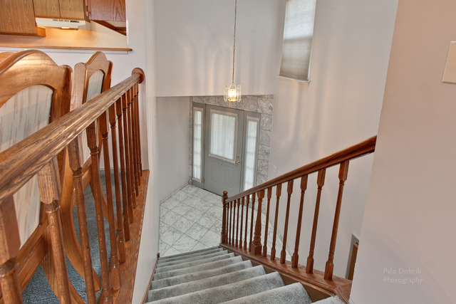 931 Ridgefield Lane Wheeling, IL 60090 - Photo 3 of 20 a view of staircase with railing and white walls