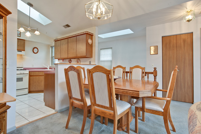 931 Ridgefield Lane Wheeling, IL 60090 - Photo 8 of 20 a dining room with furniture and chandelier