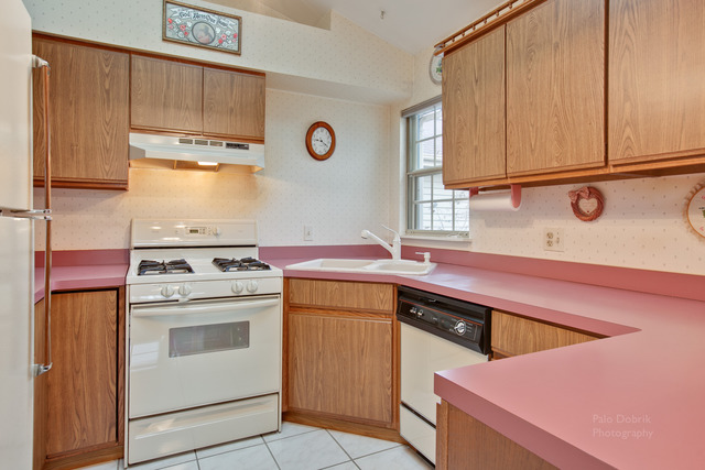 931 Ridgefield Lane Wheeling, IL 60090 - Photo 9 of 20 a kitchen with a stove sink and cabinets