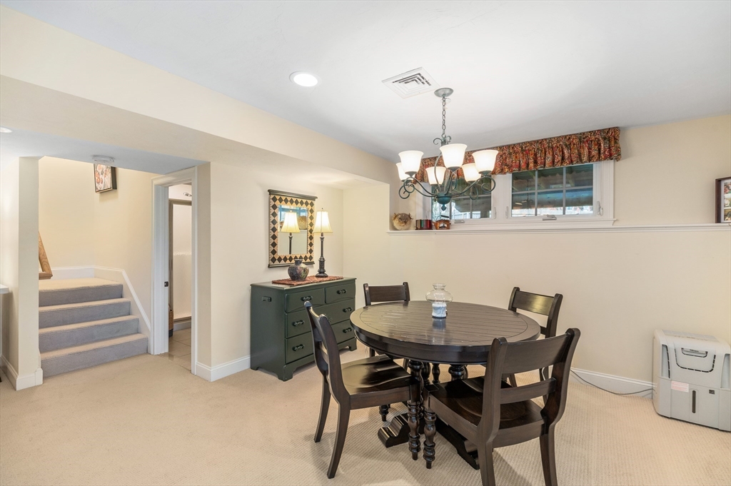 6 Essex Road, Unit 8 Ipswich, MA 01938 - Photo 24 of 35 a dining room with furniture a chandelier and wooden floor