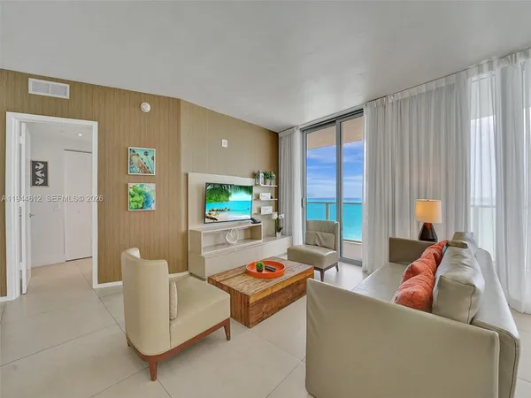 a living room with furniture and large window
