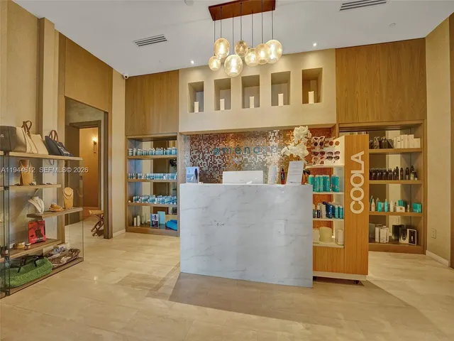 a bedroom with a bed table flowerpot and a window