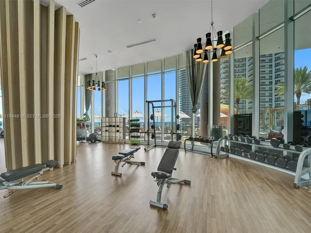a room with stainless steel appliances kitchen island granite countertop a sink and cabinets