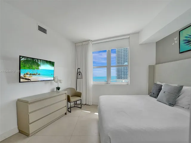 a bathroom with a double vanity sink a large mirror and shower
