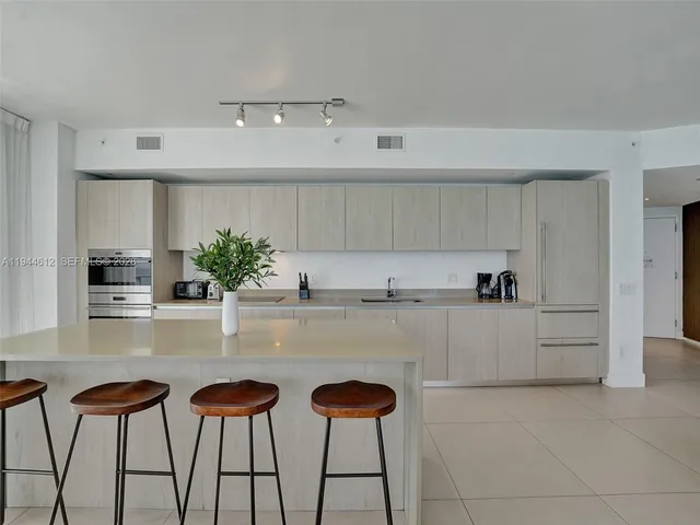 a bedroom with a bed and large flat screen tv