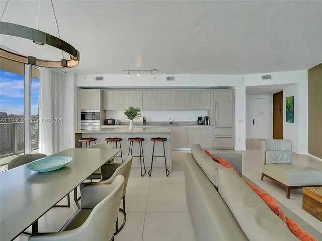 a bedroom with furniture and a large window