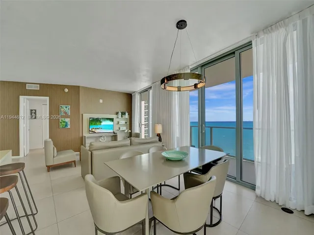 a bedroom with two beds and large window