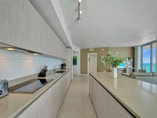 a bathroom with a granite countertop sink a toilet and shower