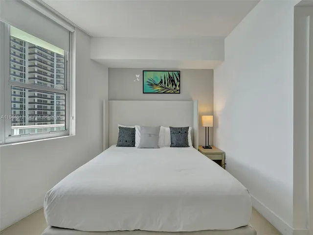 a living room with furniture a flat screen tv and a table