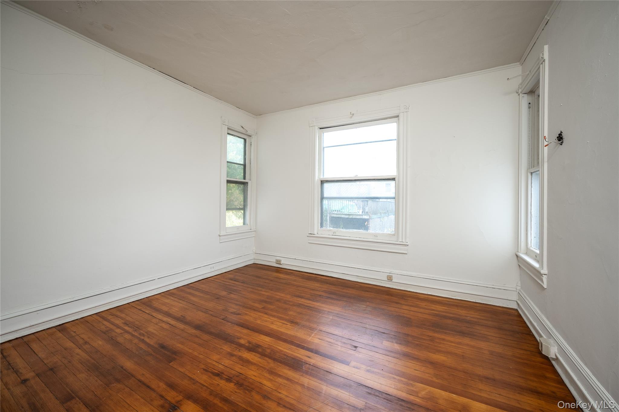 39 Hamilton Avenue Ossining, NY 10562 - Photo 12 of 22 an empty room with wooden floor and windows