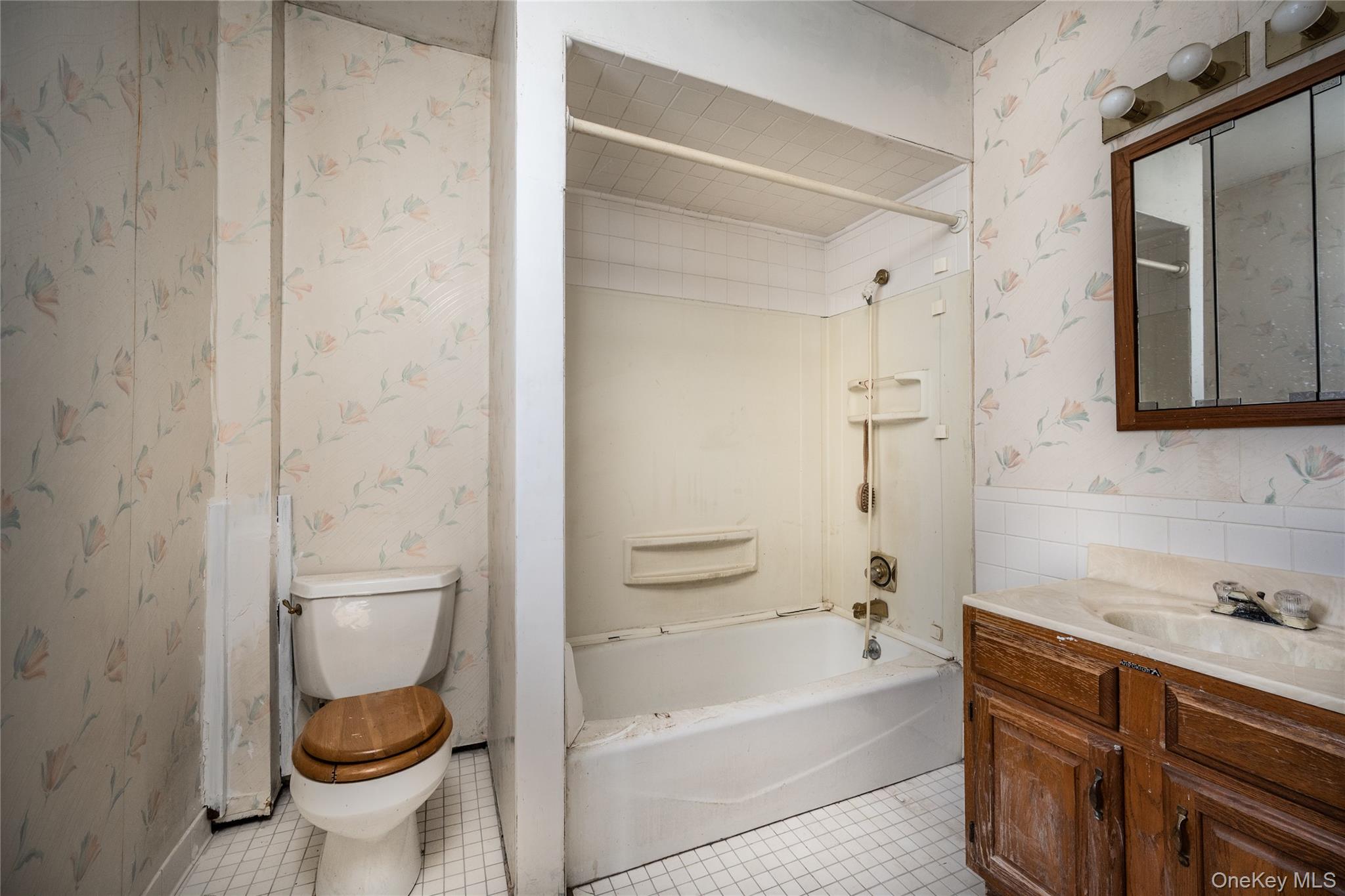 39 Hamilton Avenue Ossining, NY 10562 - Photo 14 of 22 a bathroom with a granite countertop toilet a sink and bathtub