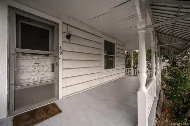 a view of front door and potted plants