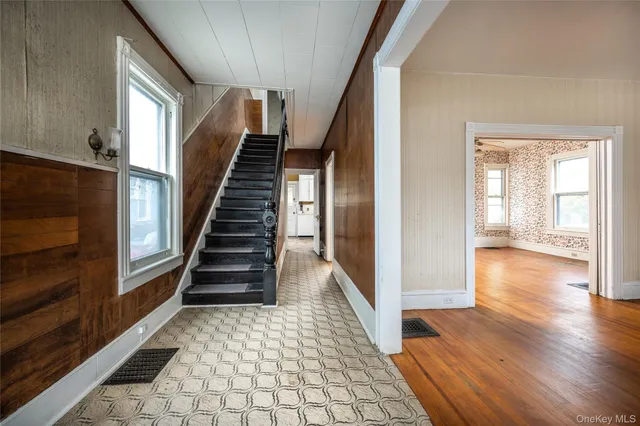 a view of entryway and hall with wooden floor