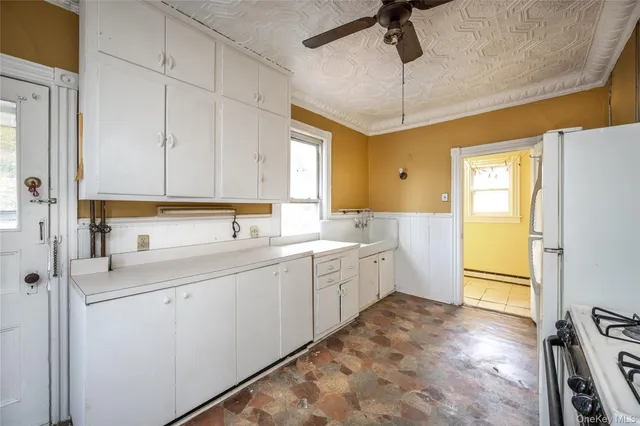 a kitchen with sink cabinets and window