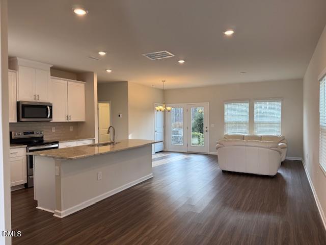 212 Brook Farm Lane Fuquay-Varina, NC 27526 - Photo 4 of 23 a large kitchen with stainless steel appliances granite countertop a lot of counter space and wooden floors
