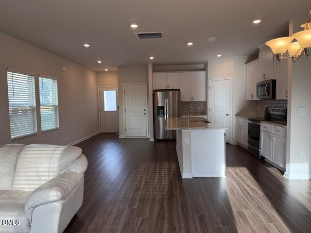 212 Brook Farm Lane Fuquay-Varina, NC 27526 - Photo 5 of 23 a kitchen with a refrigerator and a stove top oven