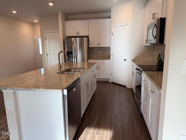212 Brook Farm Lane Fuquay-Varina, NC 27526 - Photo 6 of 23 a kitchen with kitchen island granite countertop a sink a counter top space stainless steel appliances and cabinets