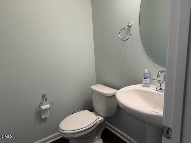 212 Brook Farm Lane Fuquay-Varina, NC 27526 - Photo 8 of 23 a white toilet sitting next to a bathroom sink