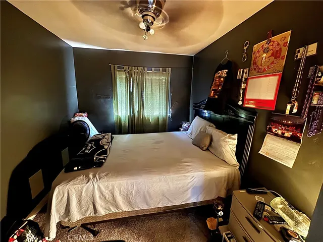 a bedroom with a bed and a flat tv screen