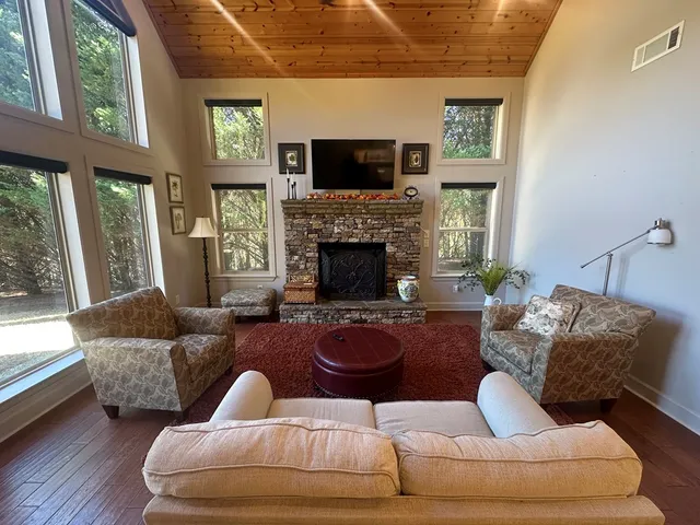 a bed sitting in a room next to a window with a rug