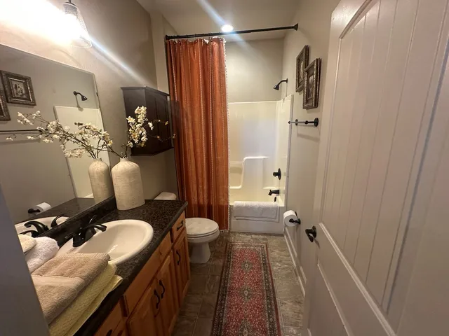 a kitchen with refrigerator and chairs