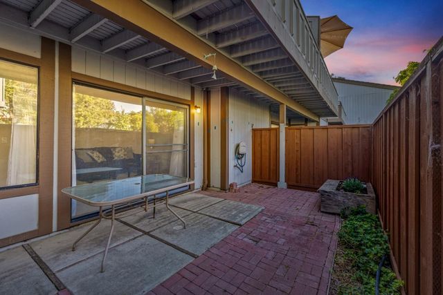 a backyard of a house with table and chairs