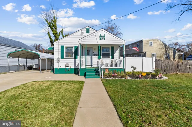 a front view of a house with a yard table and chairs
