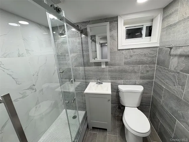 a white toilet sitting next to a bathroom sink