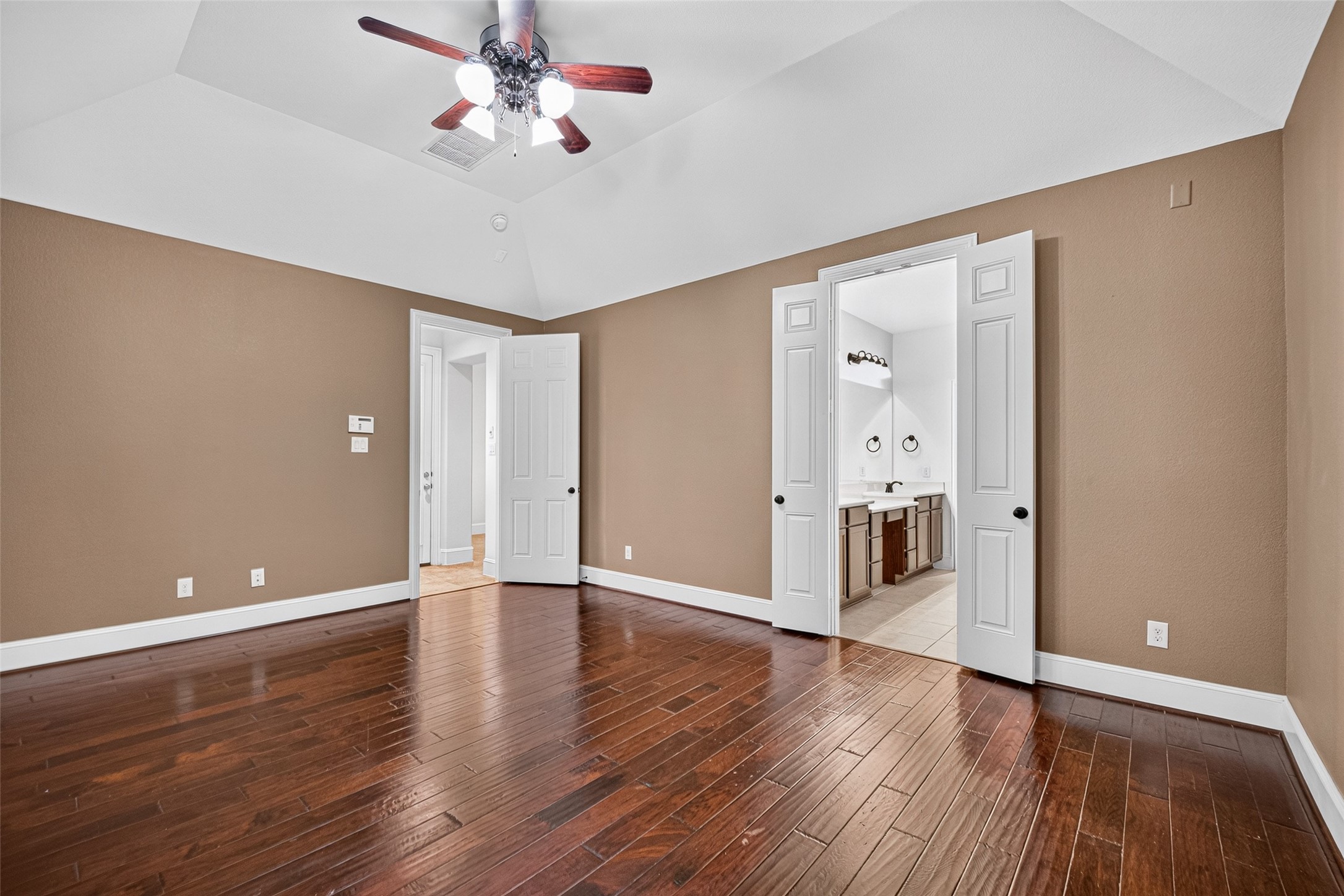 7930 Summer Night Lane Rosenberg, TX 77469 - Photo 21 of 48 Alternate view of the spacious primary bedroom featuring a tray ceiling and abundant natural light.