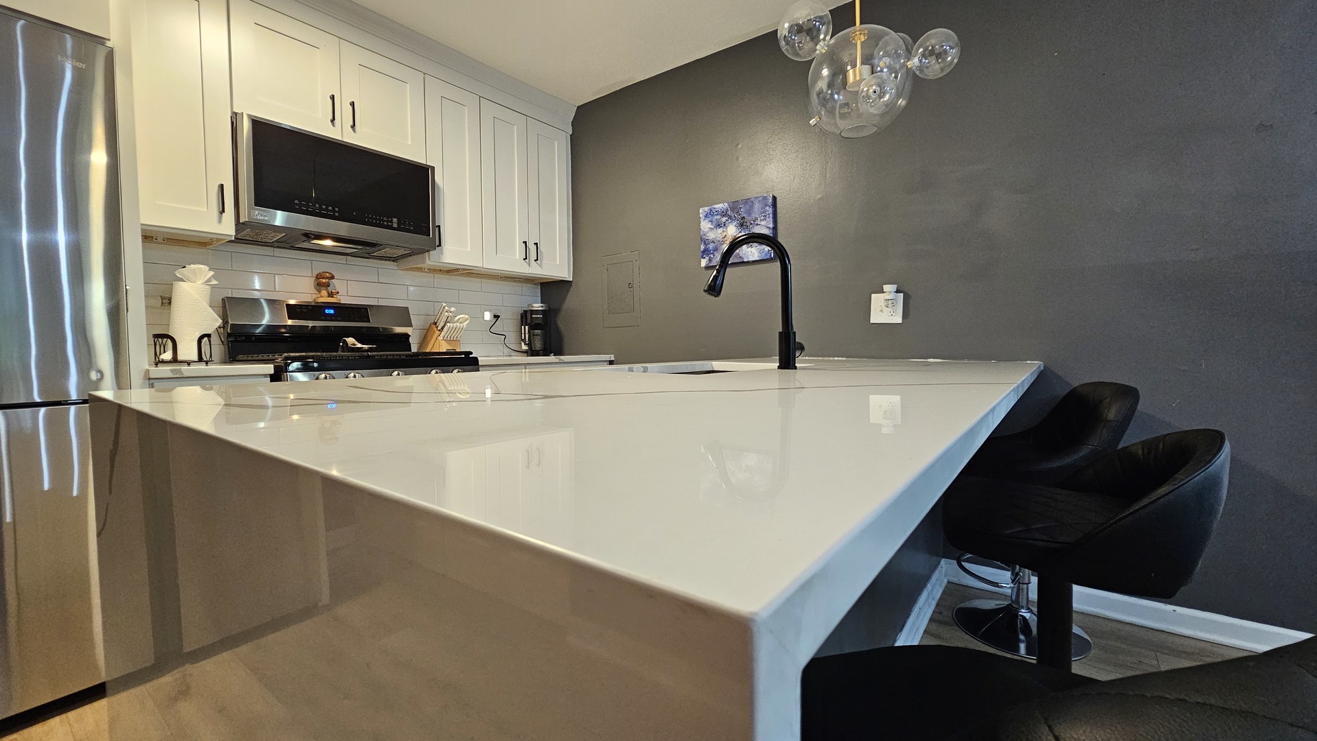 16 Forest Lane Cary, IL 60013 - Photo 14 of 50 a kitchen with a sink a microwave and cabinets