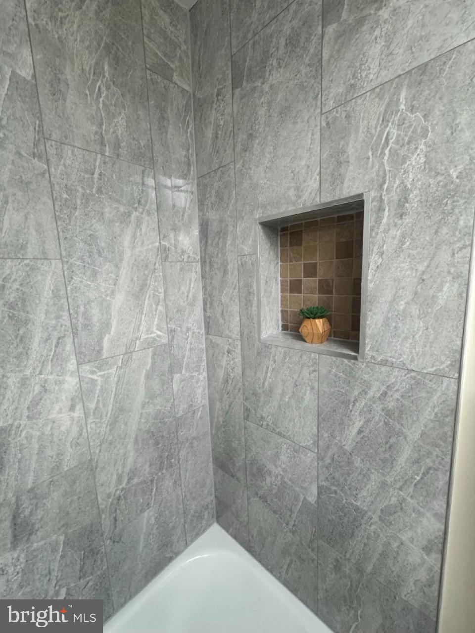 1231 Kevin Road Baltimore, MD 21229 - Photo 21 of 28 Sleek modern shower with elegant tile design.