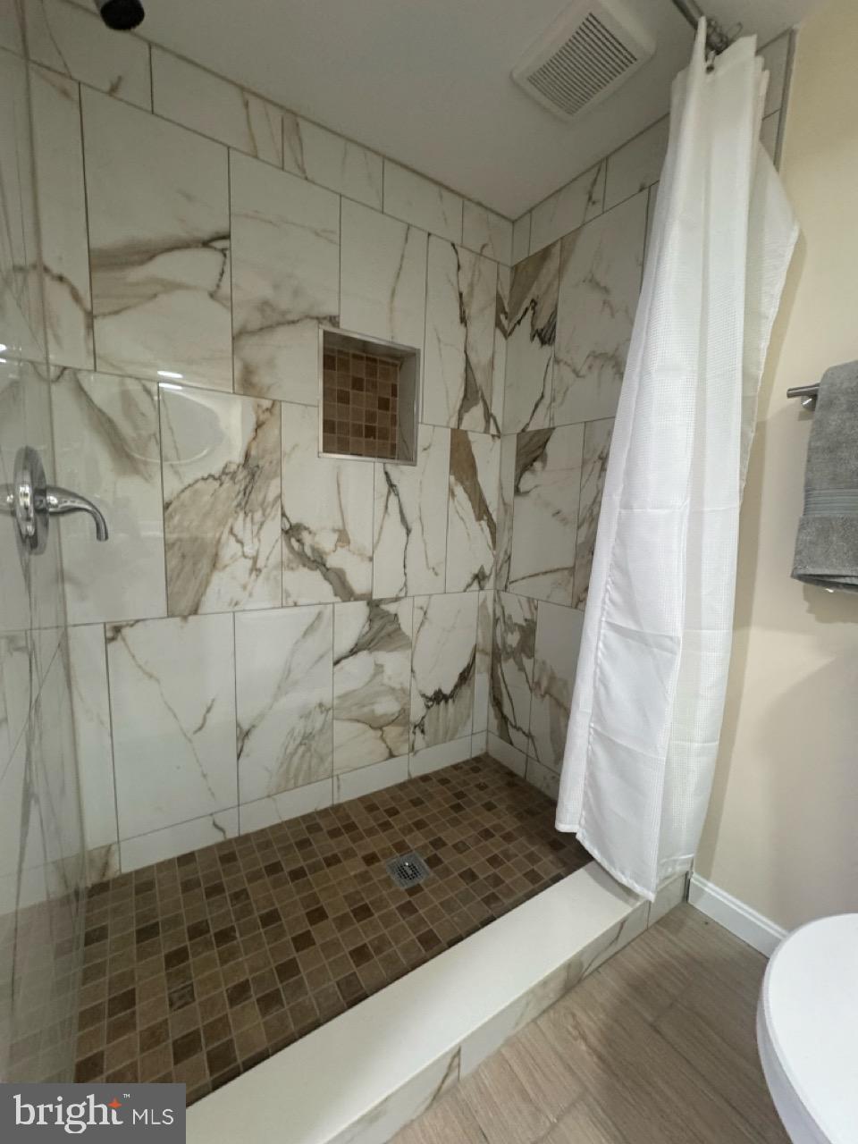 1231 Kevin Road Baltimore, MD 21229 - Photo 27 of 28 Elegant marble shower with modern design.