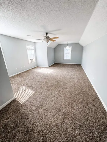 an empty room with a empty space and a ceiling fan
