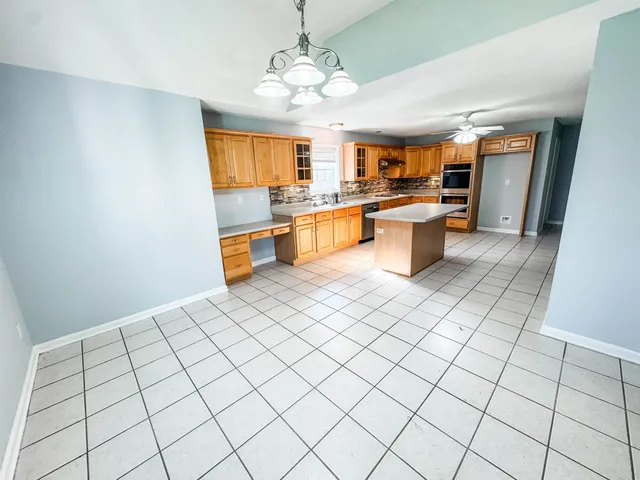 a kitchen with stainless steel appliances a sink and cabinets