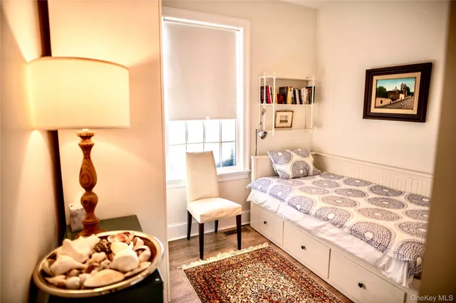 a bedroom with a bed and a table with painted walls