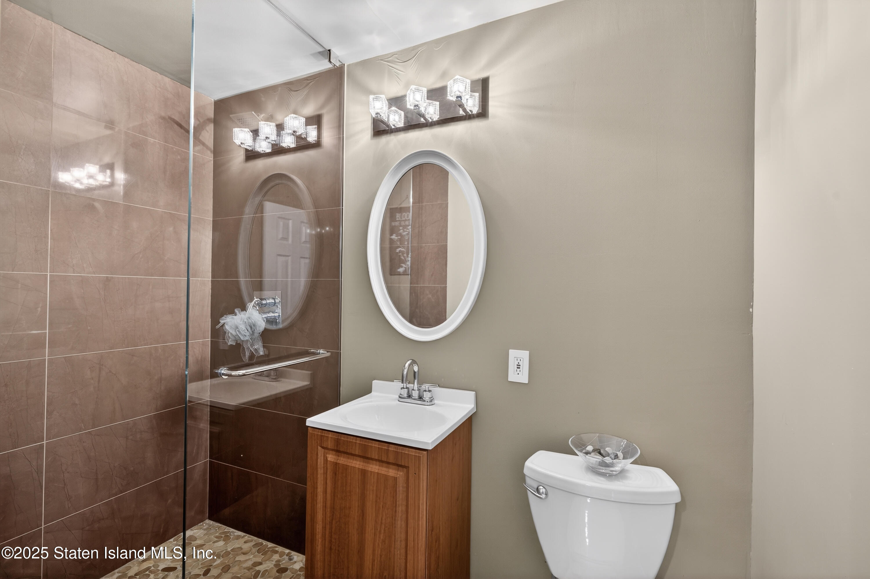 70 Annadale Road Staten Island, NY 10312 - Photo 13 of 35 a bathroom with a sink mirror and toilet