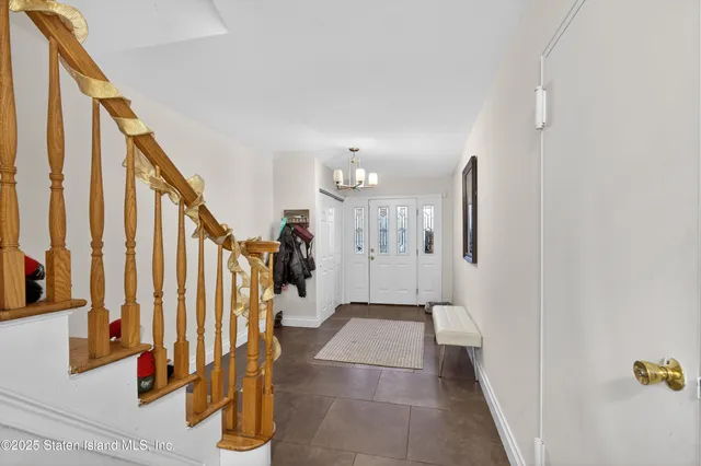 a large white kitchen with sink stove and wooden floor