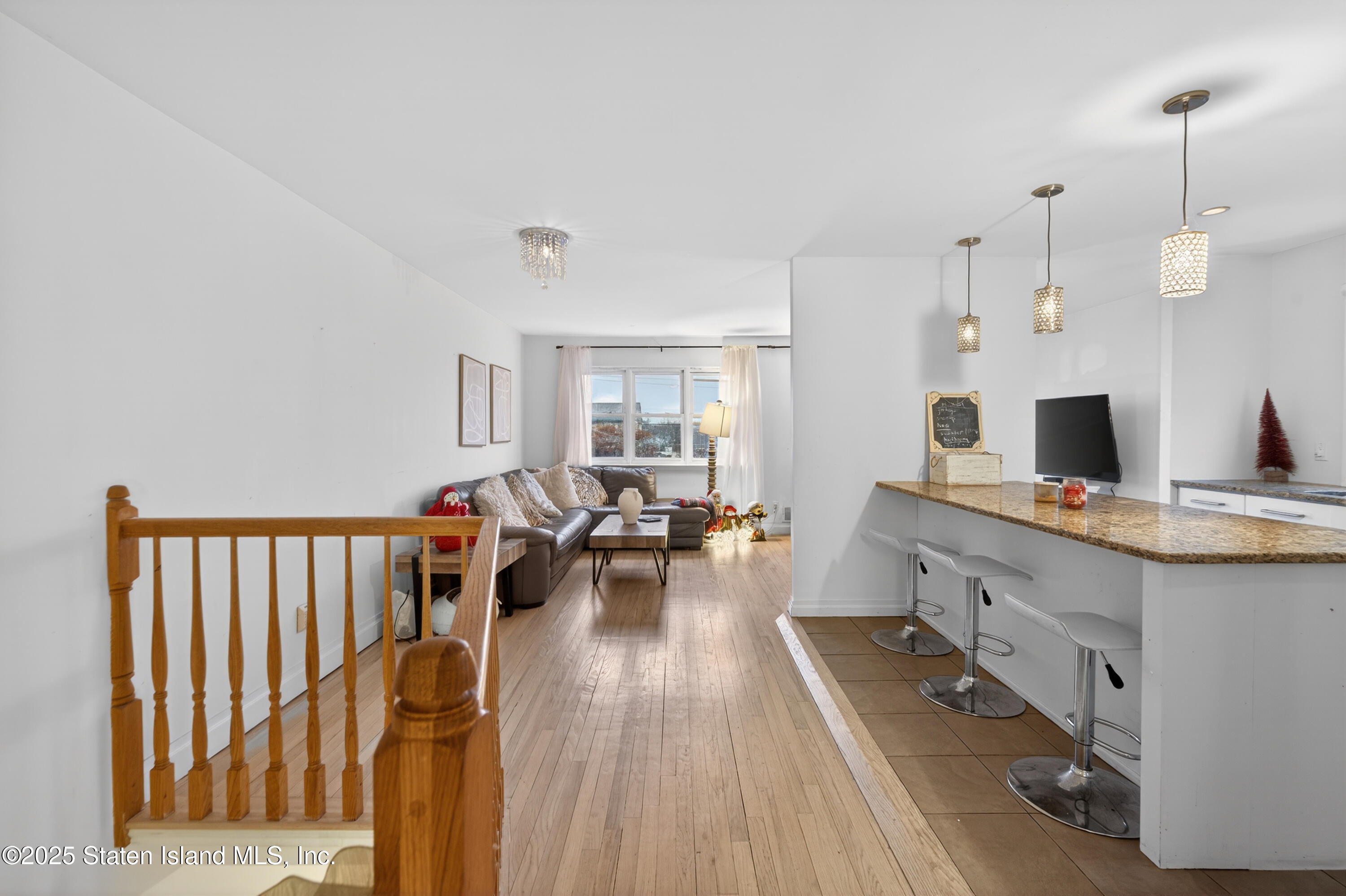 70 Annadale Road Staten Island, NY 10312 - Photo 16 of 35 a large white kitchen with sink stove and wooden floor
