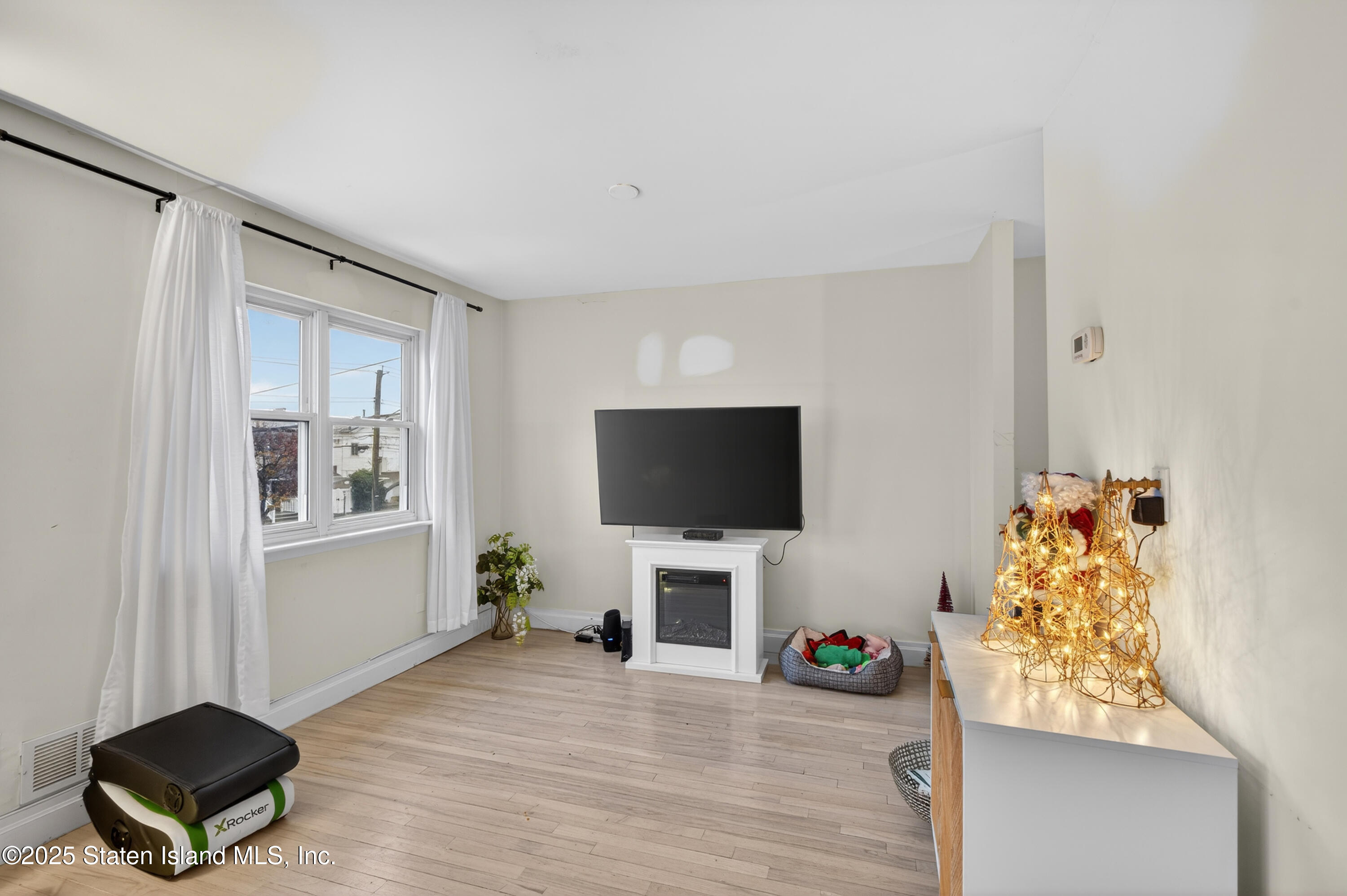 70 Annadale Road Staten Island, NY 10312 - Photo 20 of 35 a living room with furniture and a flat screen tv