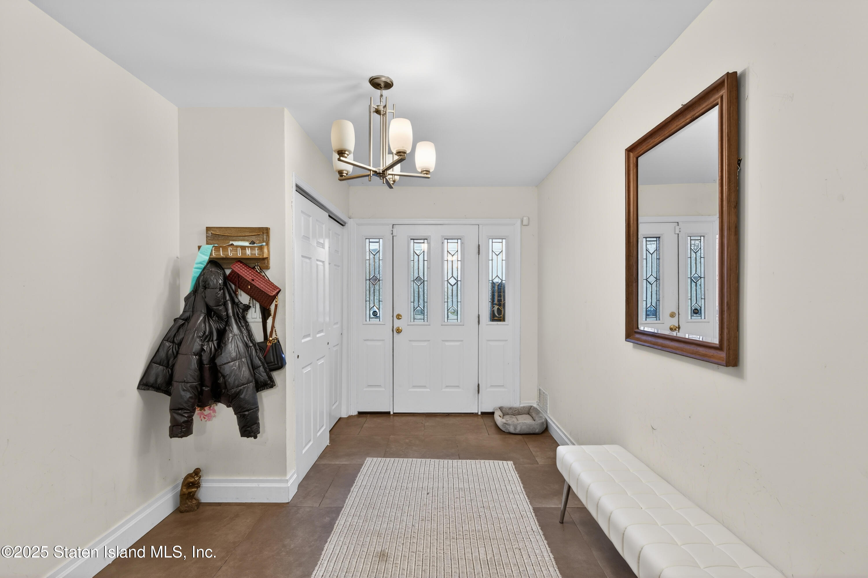 70 Annadale Road Staten Island, NY 10312 - Photo 2 of 35 a bedroom with a bed and a lamp on the table