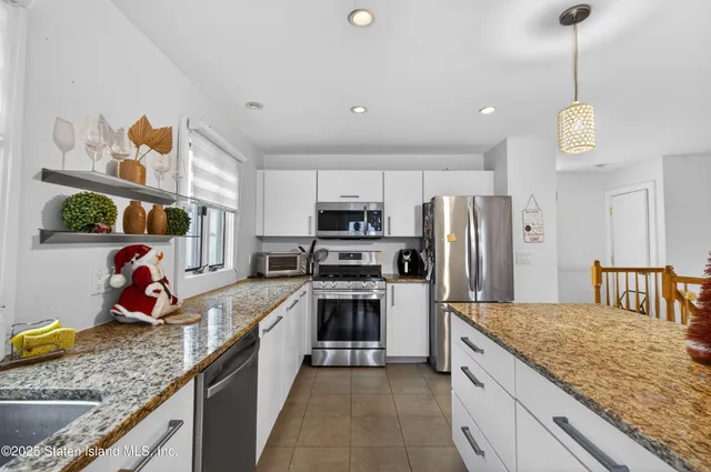 a kitchen with a stove a refrigerator and a sink