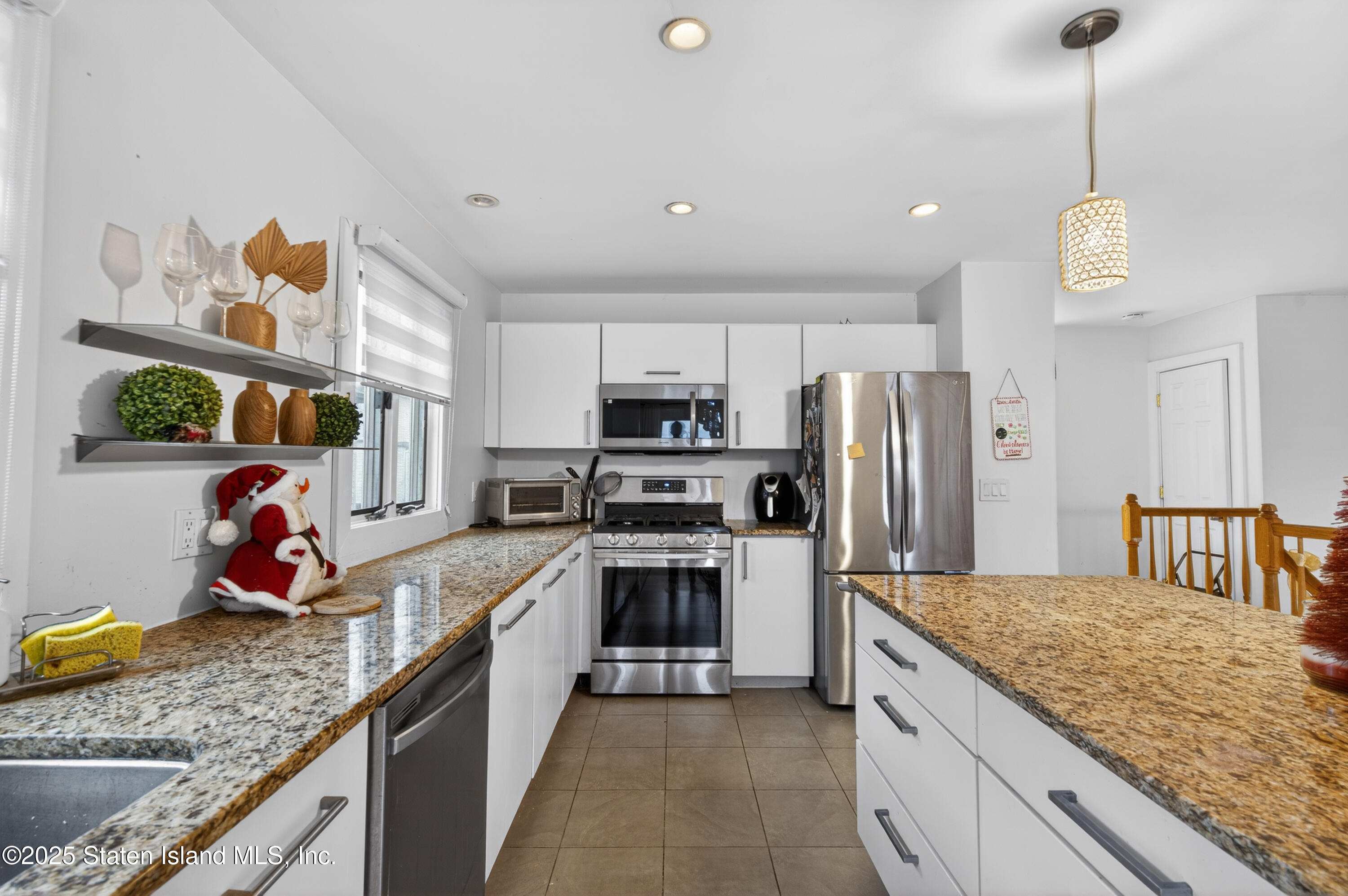 70 Annadale Road Staten Island, NY 10312 - Photo 24 of 35 a kitchen with kitchen island granite countertop a sink stainless steel appliances and cabinets