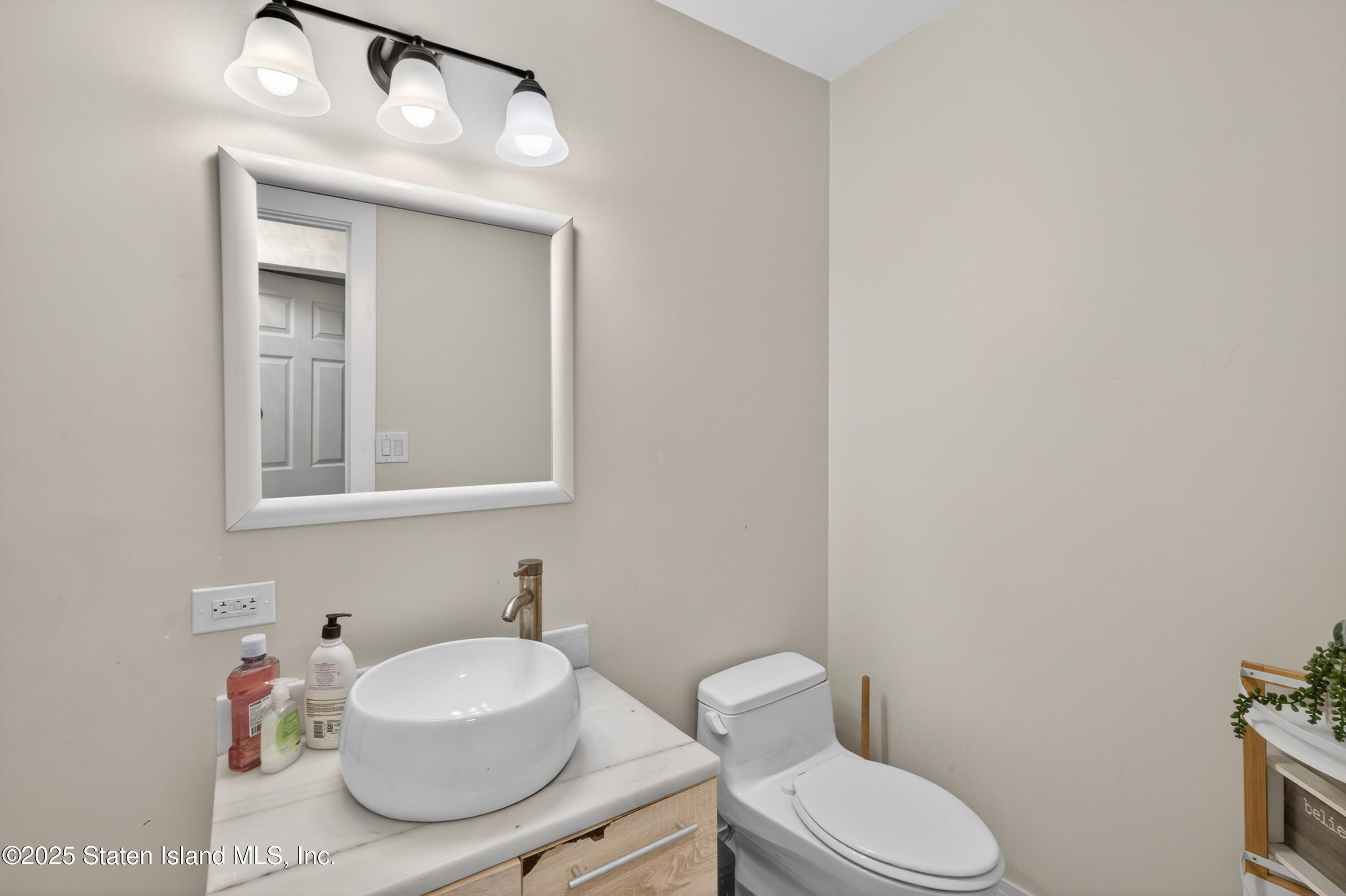 70 Annadale Road Staten Island, NY 10312 - Photo 28 of 35 a bathroom with a sink and a mirror