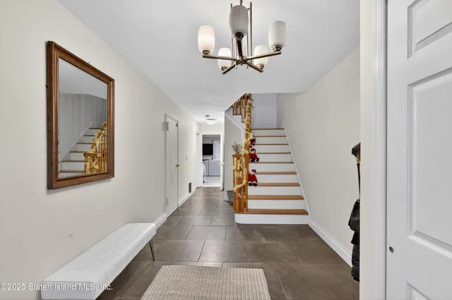 a view of entryway and hall with wooden floor