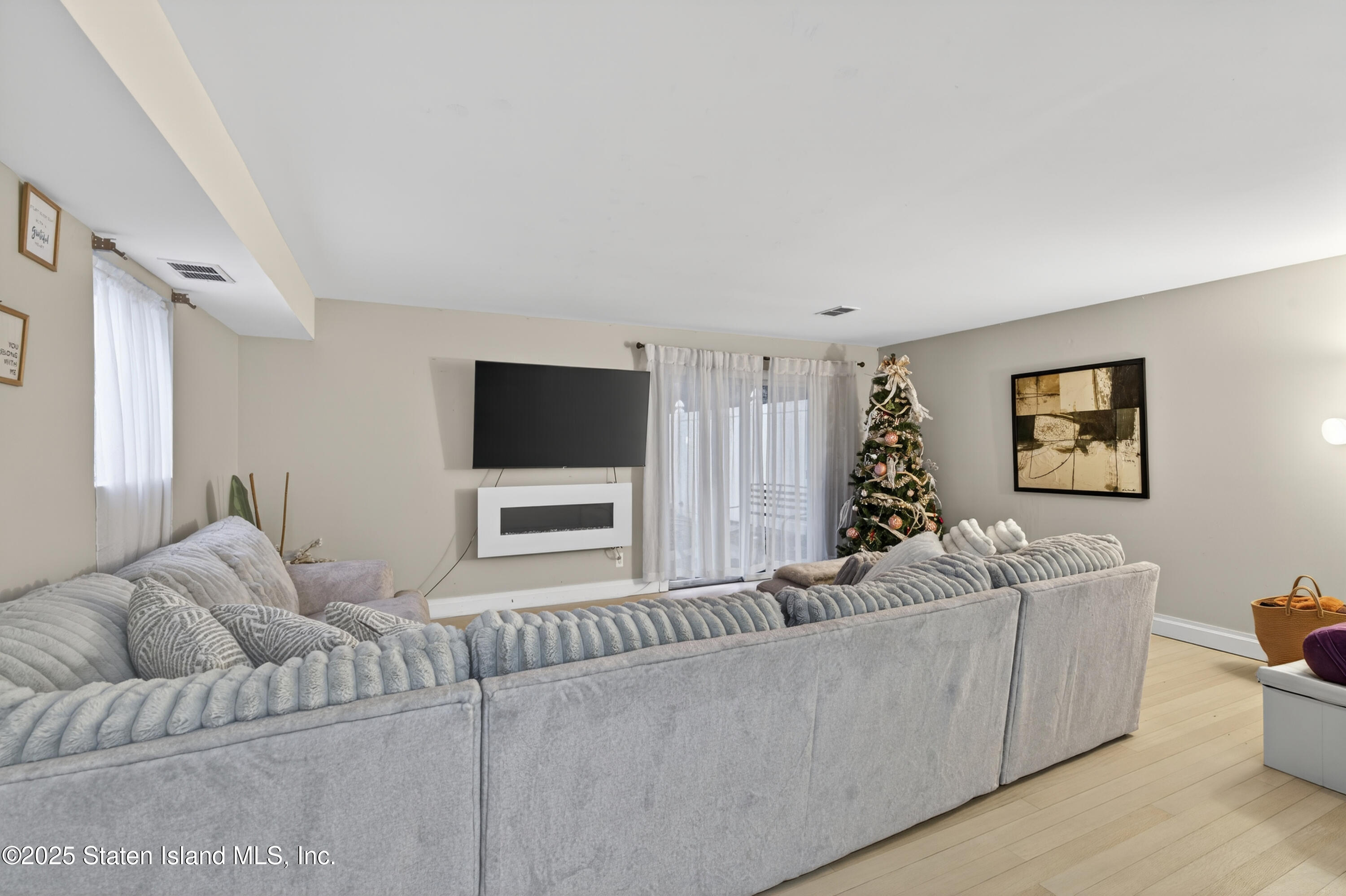 70 Annadale Road Staten Island, NY 10312 - Photo 8 of 35 a living room with furniture and a flat screen tv
