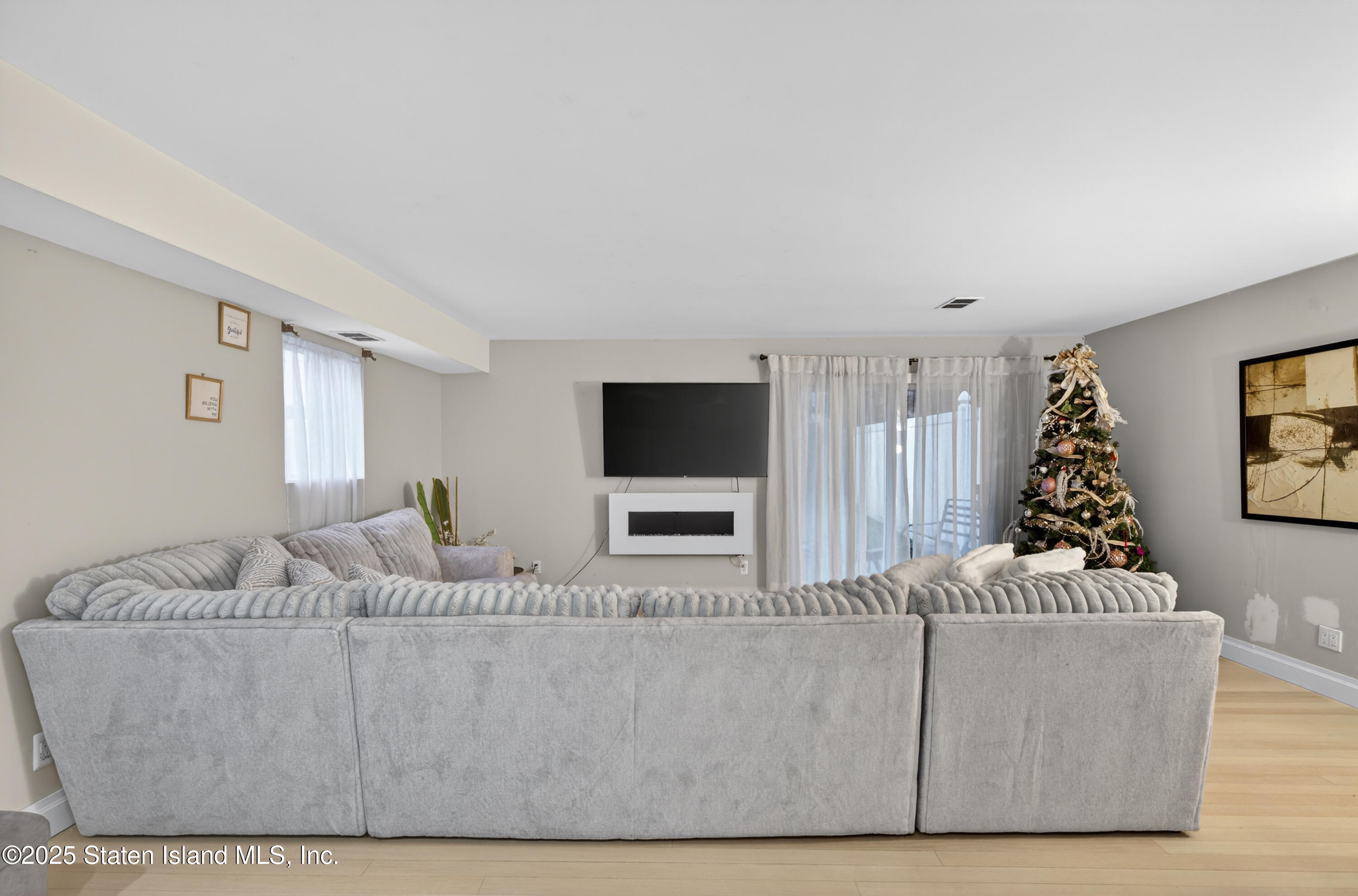 70 Annadale Road Staten Island, NY 10312 - Photo 9 of 35 a living room with furniture and a flat screen tv