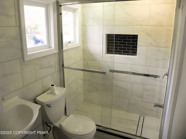 a view of a balcony with a large window and wooden floor